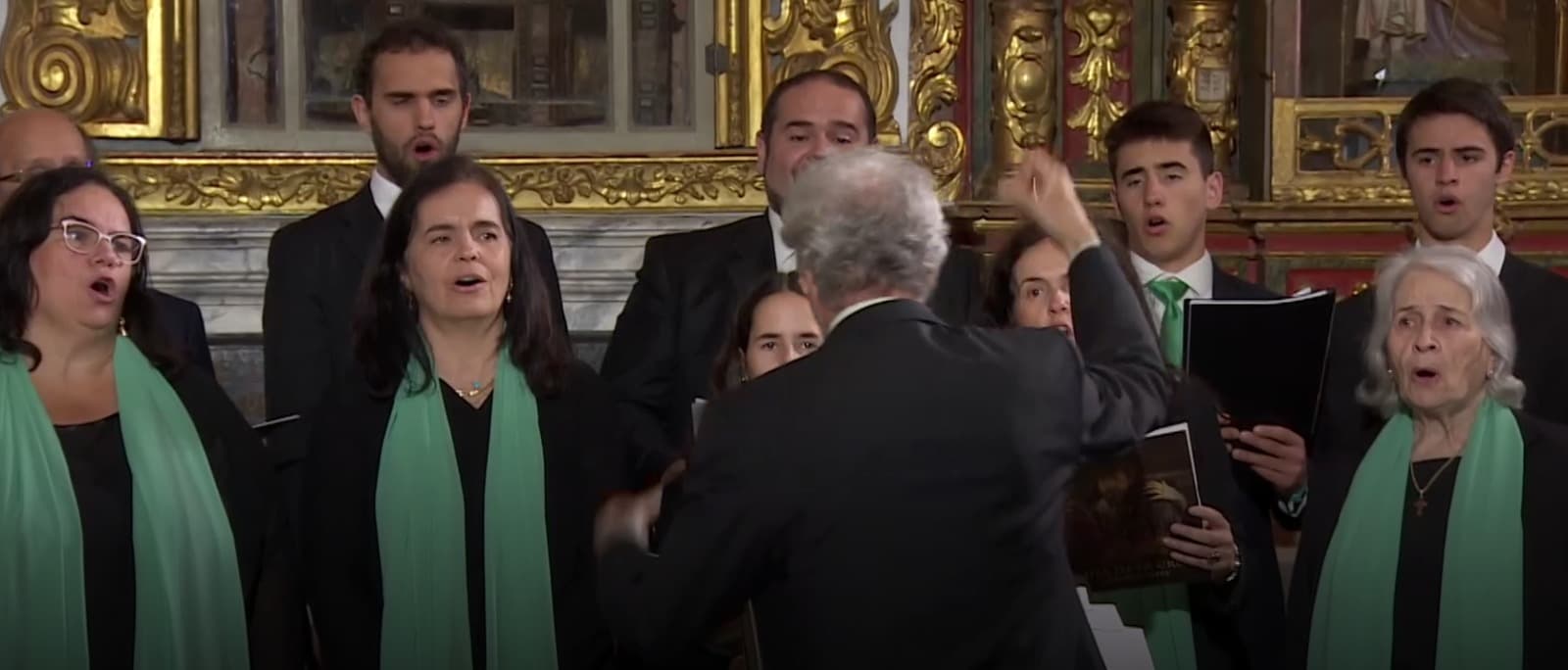 Ignacio Yepes dirigiendo al coro ante el retablo